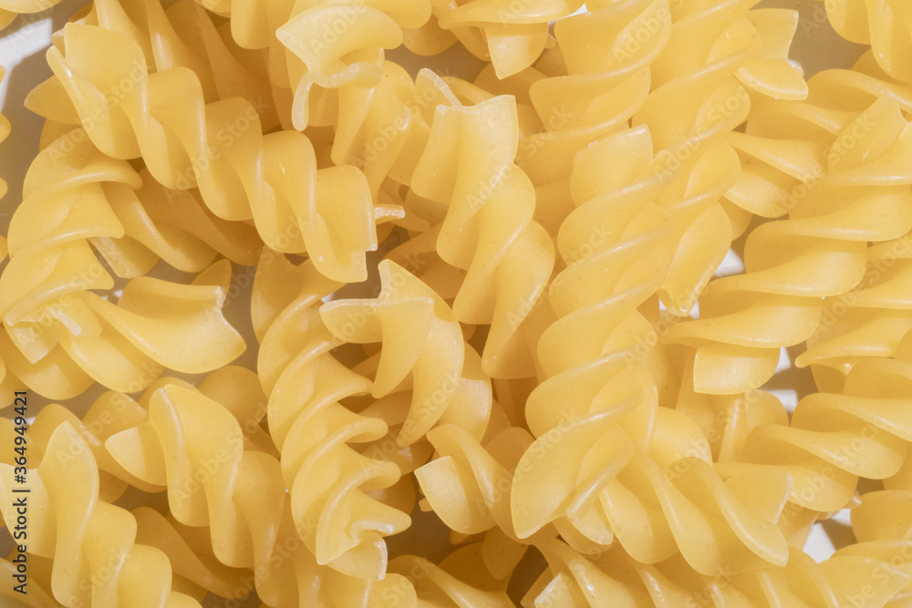 Fusilli Spiral Dry Raw Pasta Background Fusilli pasta italian spiral pattern texture background Traditional italian food Fusilli Spiral Dry Raw Pasta Background Fusilli pasta italian spiral pattern texture background Traditional italian food