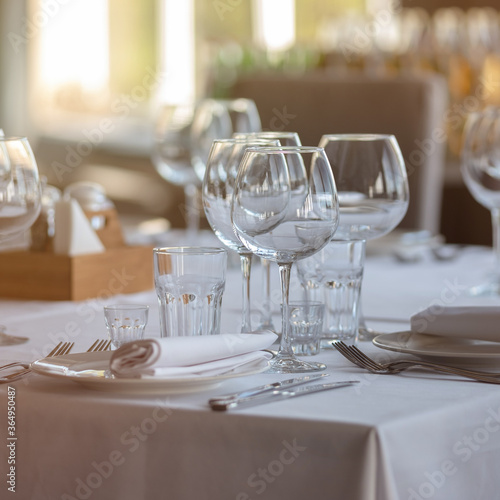 Empty glasses in restaurant background. Table set for an event party or wedding reception.