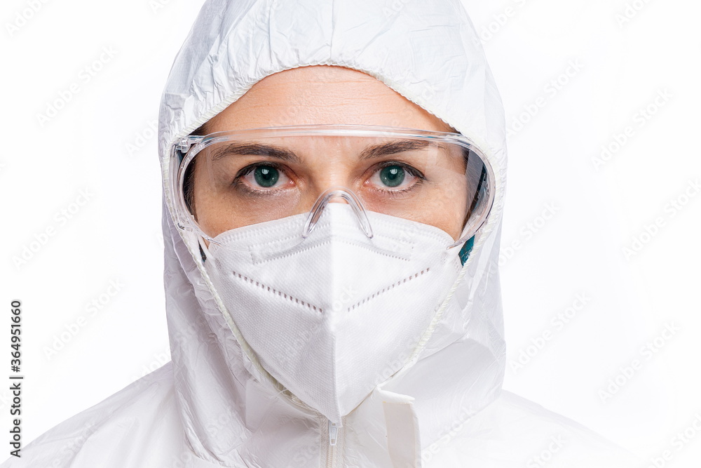 Female doctor with PPE looking at camera with white background Female doctor with PPE looking at camera with white background