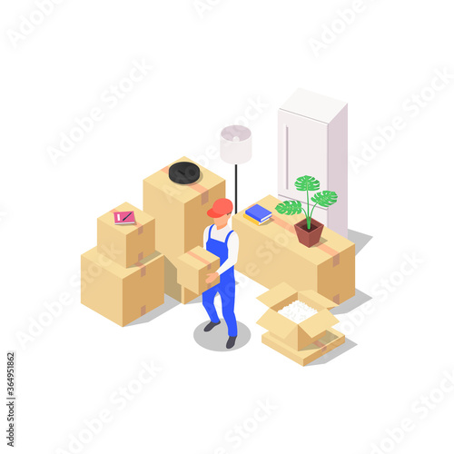 Home moving concept. A set of packed boxes with various household items and a loader holding a box in his hands.