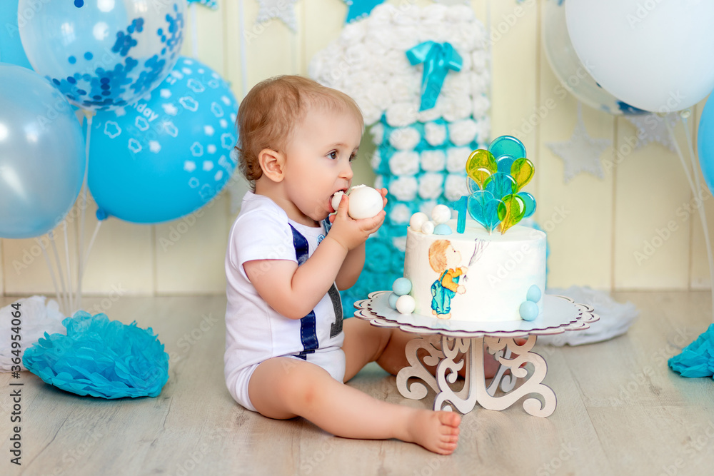baby boy eating his cake with his hands, baby 1 year old, happy childhood, children's birthday