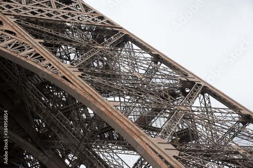 close-up Eiffel Tower, landmark of Paris, during renovation process. view with iron construction detail.