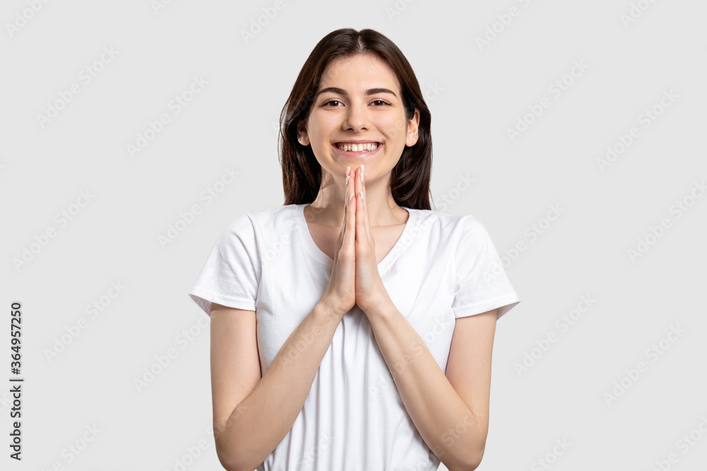 Please gesture. Wish expectation. Enthusiastic woman asking for favor isolated on light background. Please gesture. Wish expectation. Enthusiastic woman asking for favor isolated on light background.