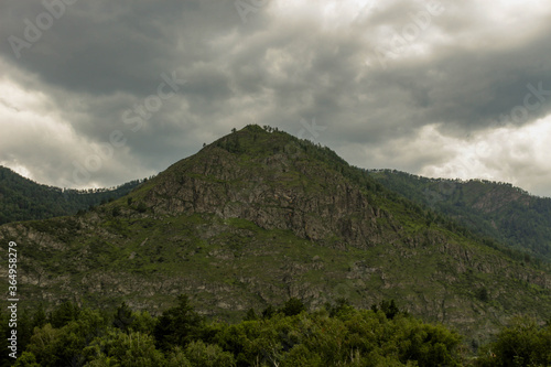 A lonely peak surrounded by mountains