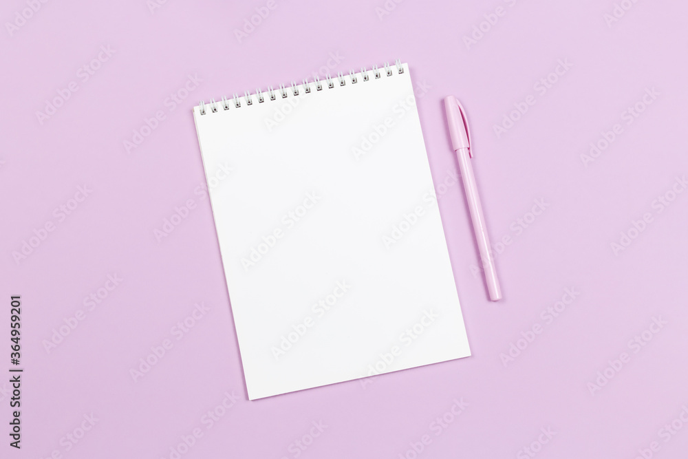 Notebook with blank page and pen on a violet pastel background. Notebook with blank page and pen on a violet pastel background.
