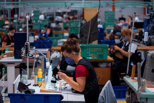 Shoe making process in footwear factory.