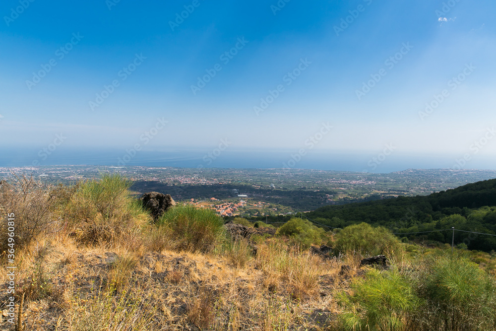 View on the village Taormina. Houses in the small village near volcano. Ground, plants, grass. Sicily, Italy. 