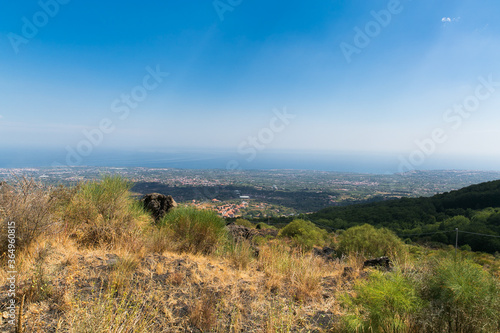 View on the village Taormina. Houses in the small village near volcano. Ground, plants, grass. Sicily, Italy. 