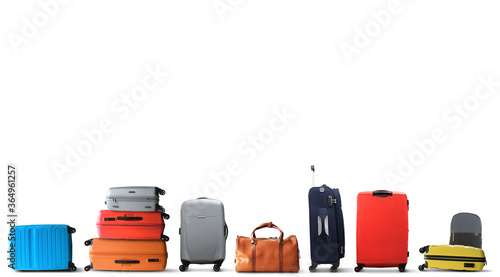 Large multicolored tourist suitcases stand in a row photo