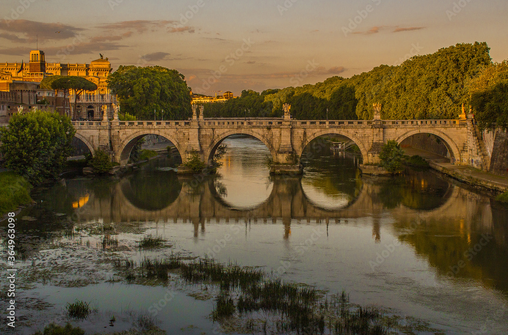 Sunset over the Sant'Angelo Bridge in Rome, Italy.