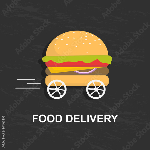 Big tasty hamburger on wheels over black background, creative image