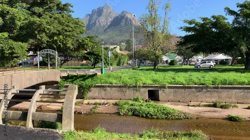 Pedestrian bridge Liesbeek river Rosebank the first river Jan van Riebeeck named  with views of Rhodes Memorial on Devils Peak Cape Town photo