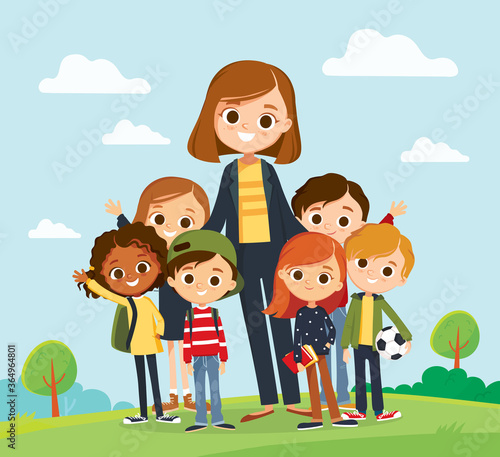 Pretty teacher standing with pupils in school yard. Classmates portrait with teacher on landscape background. Elementary school.