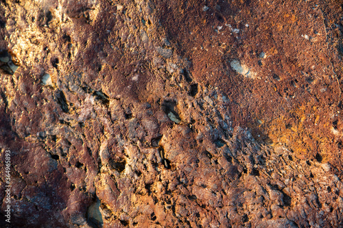 Texture of a Red Stone on the Beach
