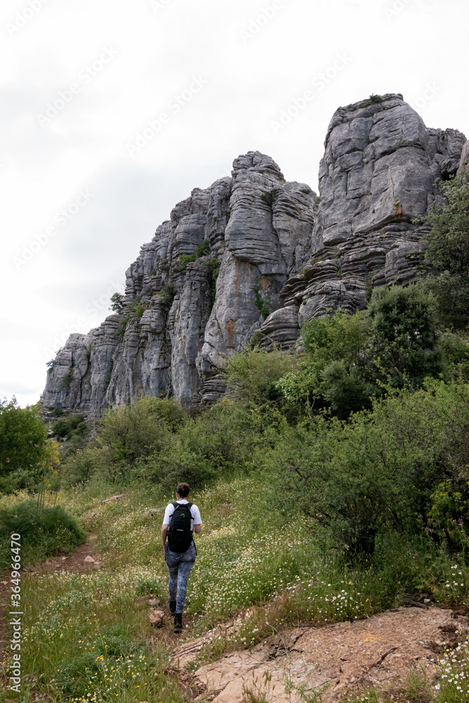 woman walking in rocky mountains woman walking in rocky mountains