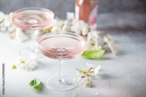 Homemade pink vodka cosmopolitan cocktail drink in crystal glasses photo