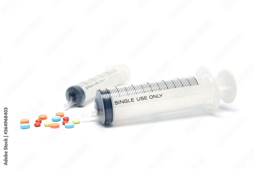 Two medical syringe and pill on white background. selective focus, soft focus. Two medical syringe and pill on white background. selective focus, soft focus.
