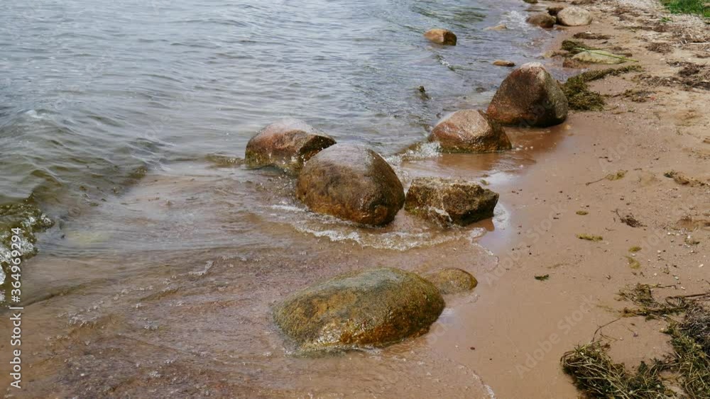 rocks on the beach in the water washed by the waves rocks on the beach in the water washed by the waves