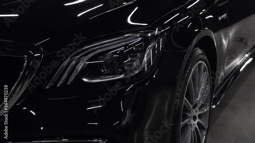 Close up of details of headlights of anonymous prestigious black luxury modern car. Concept of passion for driving cars, car dealerships,luxury cars. Shot in 4K. Head light