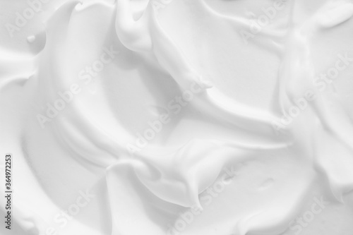 White cosmetic foam texture background. Thick mousse, cleanser, shaving foam, shampoo lather. Creamyy skincare product closeup. photo