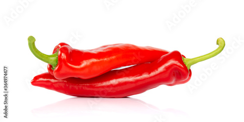 Two red hot chili pepper isolated on white background, looking like people having sex in 69 posture