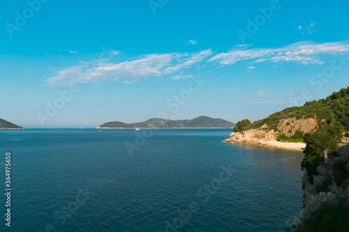 Sea view on Adriatic Sea in Croatia. Green forest, mountains, blue sea, coastline. Summer holidays in Croatia.  © Iryna Boro