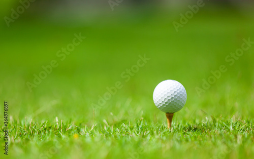 .The golf ball stands at the starting point, preparing to compete on holidays.