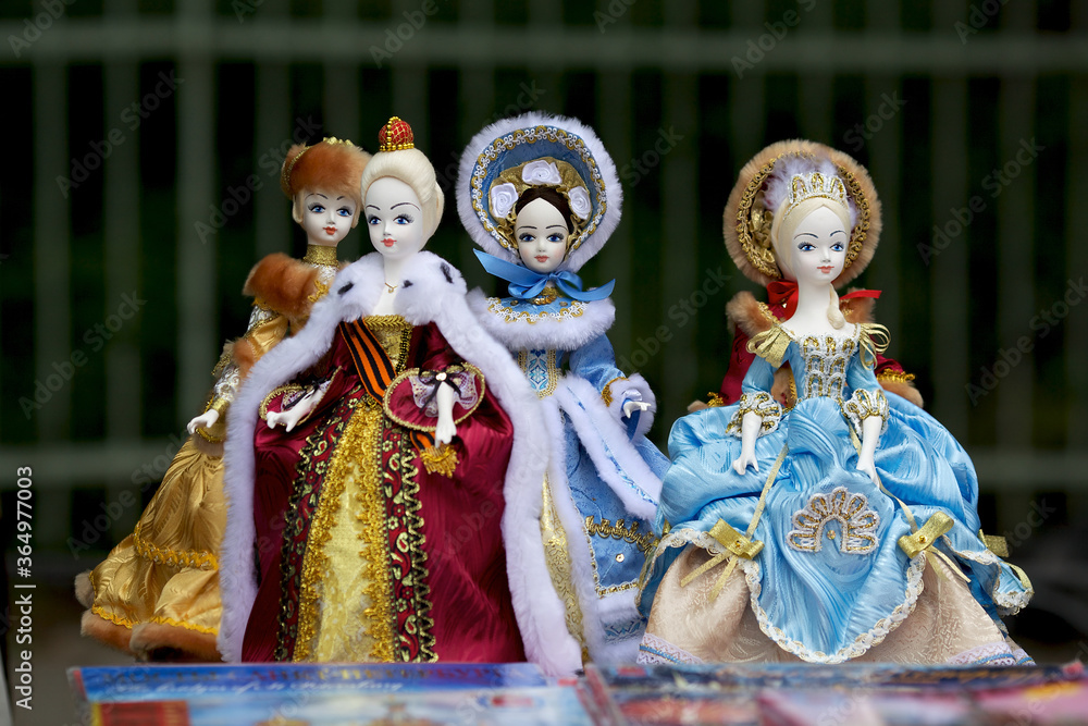 Russian souvenir, a group of porcelain dolls in national costumes of different eras of the Russian Empire