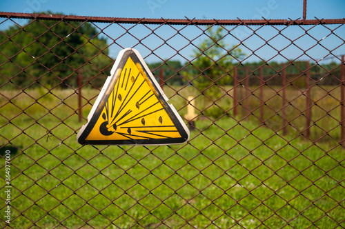 Explosion danger sign hanging on the fence around the gas installation