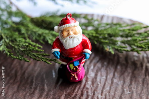 postcard mockup. spruce branch with cones, Christmas toys and a figure of Santa Claus on a white background. place for text. invitation. congratulation