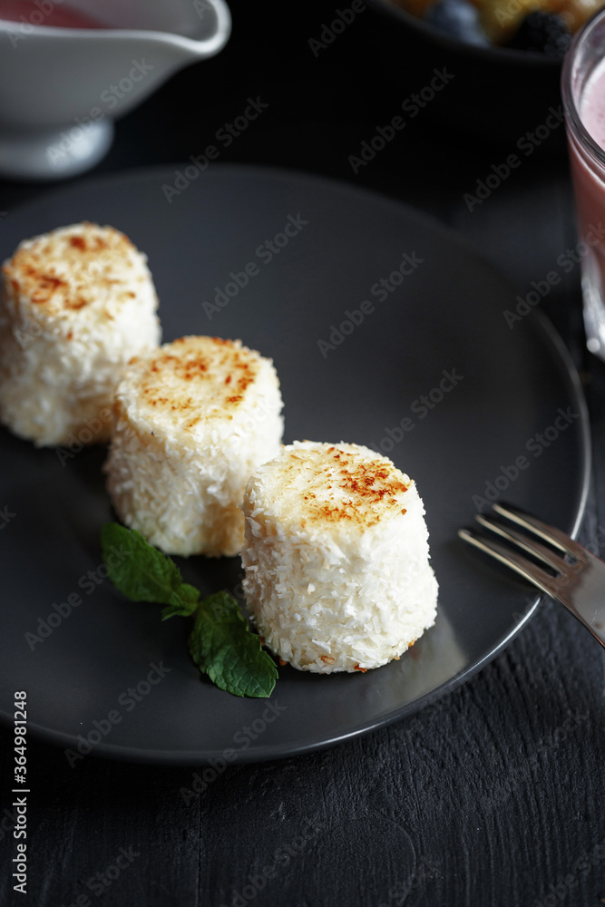 Various culinary dishes on a dark wooden table. Exquisite restaurant serve on dark dishes Various culinary dishes on a dark wooden table. Exquisite restaurant serve on dark dishes