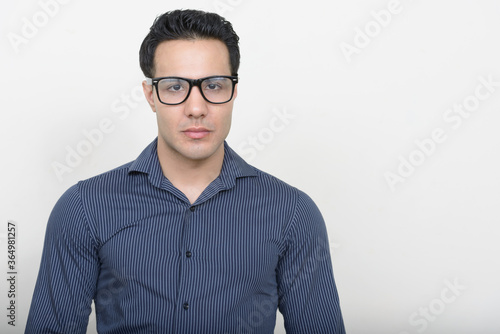 Portrait of young handsome businessman against white background © Ranta Images