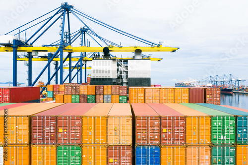 Rear view container ship. Business logistic transportation sea freight, Cargo ship, Cargo container in deep sea port at industrial estate for import export around in the world,