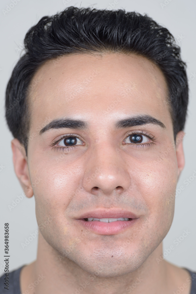 Portrait of young handsome man against white background