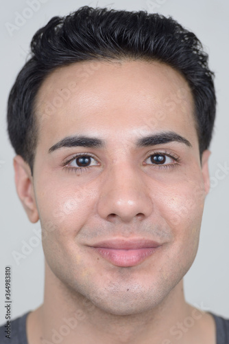 Portrait of young handsome man against white background