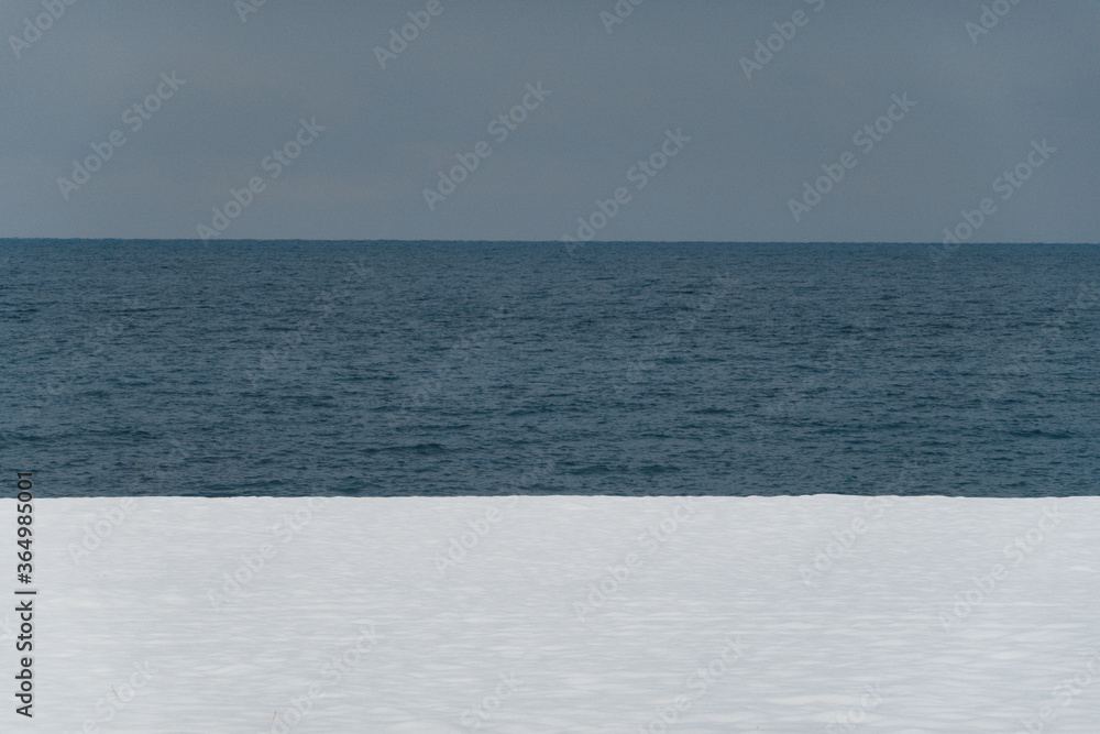Winter sea. Snowy beach. White and blue. Winter sea. Snowy beach. White and blue.