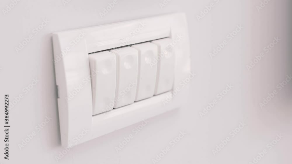 Clicking and turning off a light switch in room or office - close up shot Clicking and turning off a light switch in room or office - close up shot