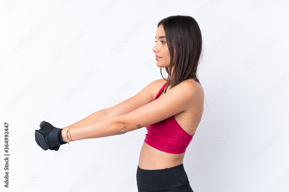 Young sport brunette woman over isolated white background stretching Young sport brunette woman over isolated white background stretching