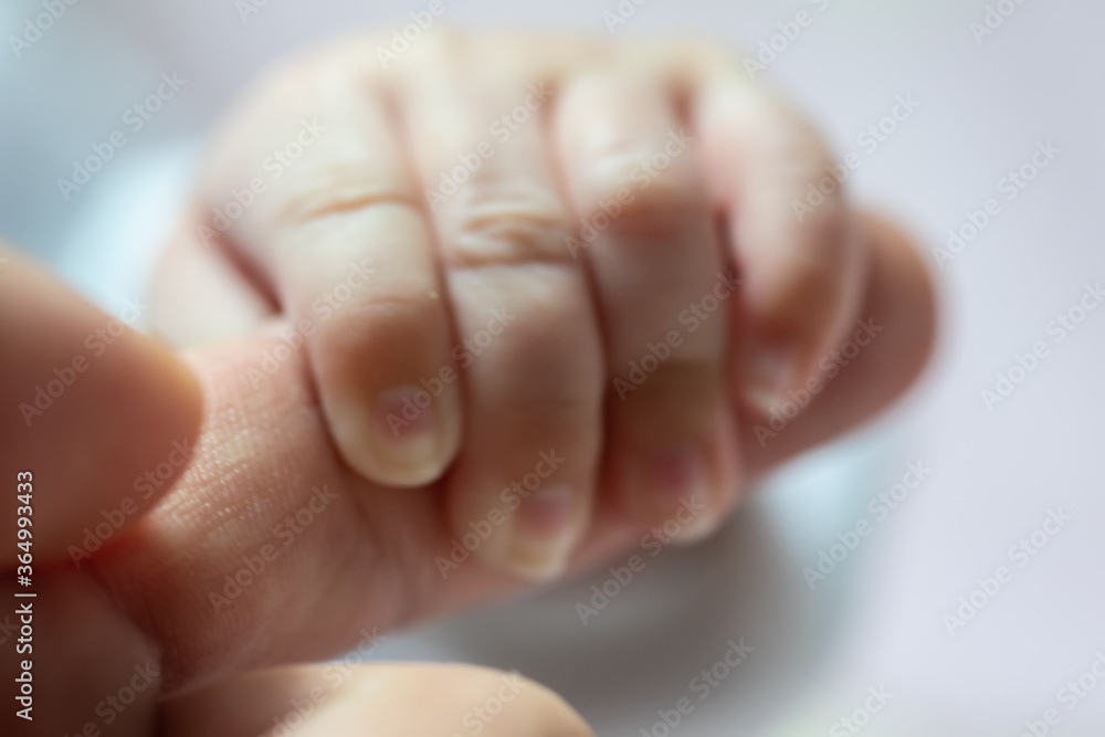 Abstract blur image of Newborn children's hand in mother hand. Mom and her Child. Happy Family concept. Beautiful conceptual image of Maternity Abstract blur image of Newborn children's hand in mother hand. Mom and her Child. Happy Family concept. Beautiful conceptual image of Maternity