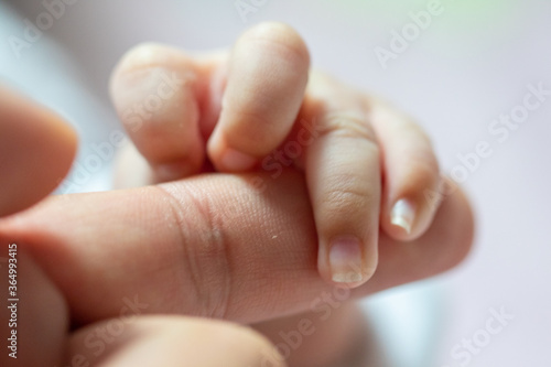 Abstract blur image of Newborn children's hand in mother hand. Mom and her Child. Happy Family concept. Beautiful conceptual image of Maternity