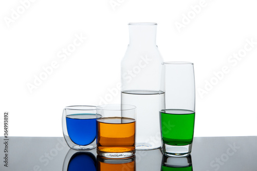 Different types of glasses with different drinks and colors, isolated on white.