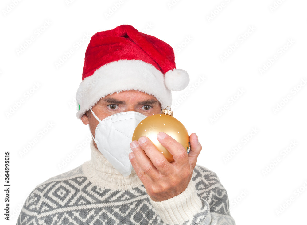 Man in Santa Claus hat and medical mask with christmas ball on white background Man in Santa Claus hat and medical mask with christmas ball on white background