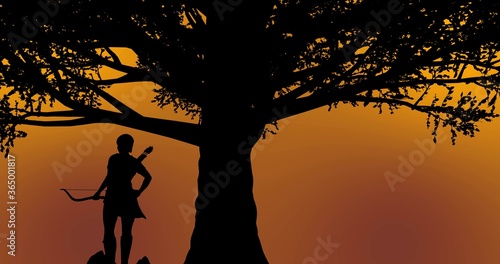 Beautiful warrior girl standing under a tree during sunset time orange-yellow background