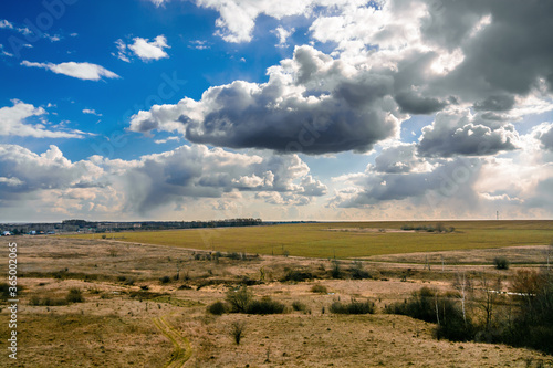 Clouds with virga over the field and river