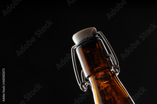 Beer bottle on dark background, copy space