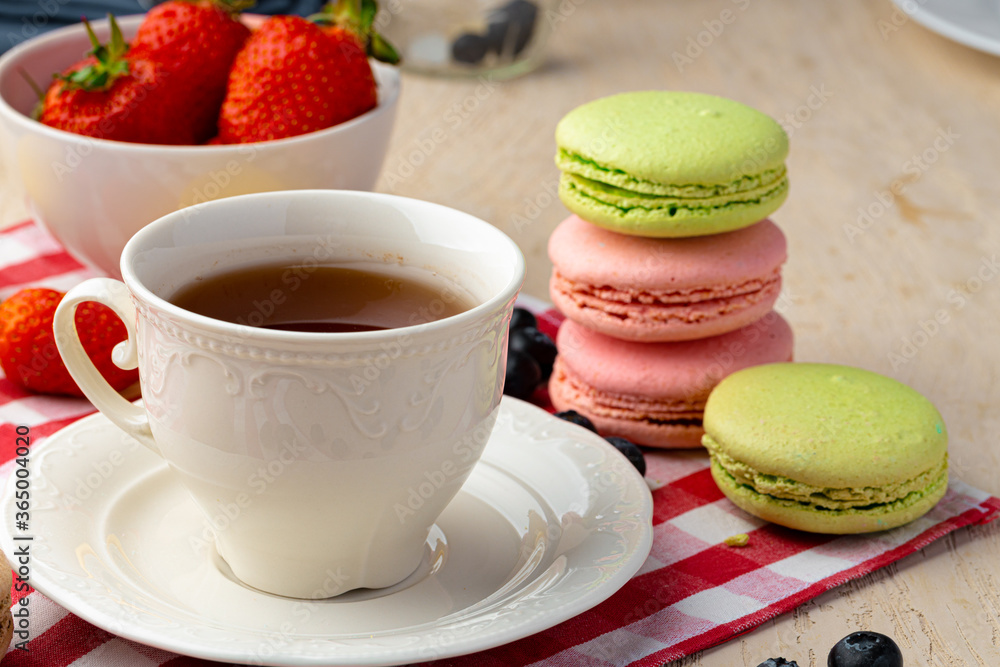 Cup of coffee with colorful cookies close up Cup of coffee with colorful cookies close up