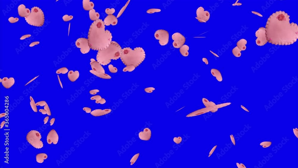 Homemade heart shaped pink cookies decorated with a flower falling down on the blue background
Homemade heart shaped pink cookies decorated with a flower falling down on the blue background
