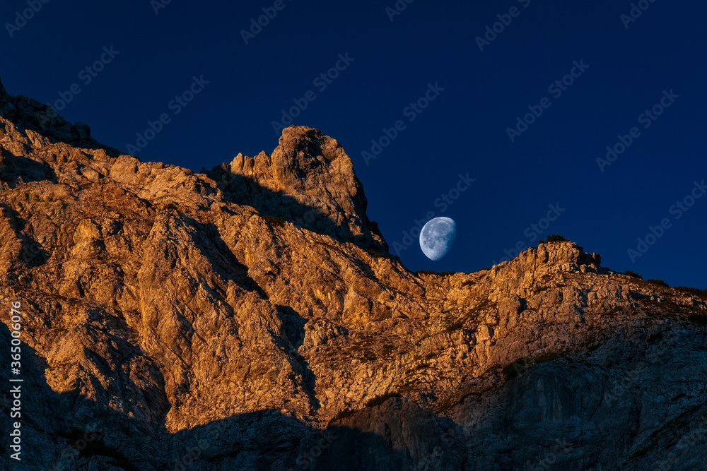 Moonrise with sunset colors on the mountains in the alps near Lermoos ehrwald reutte in tyrol austria