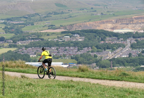 young man riding a bike with countryside view