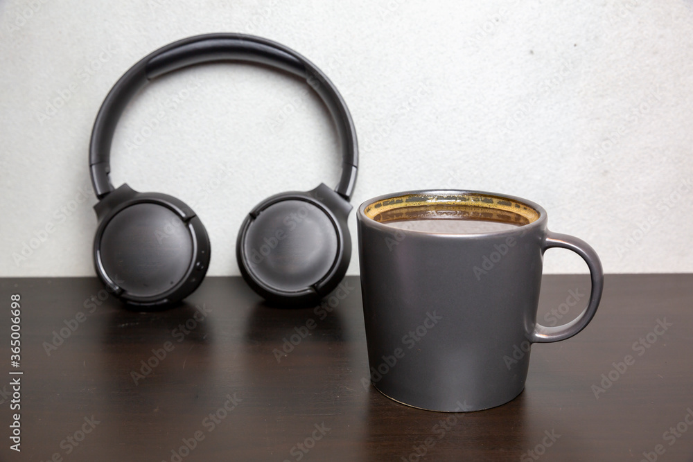 front view coffee cup and headphone on wooden table front view coffee cup and headphone on wooden table